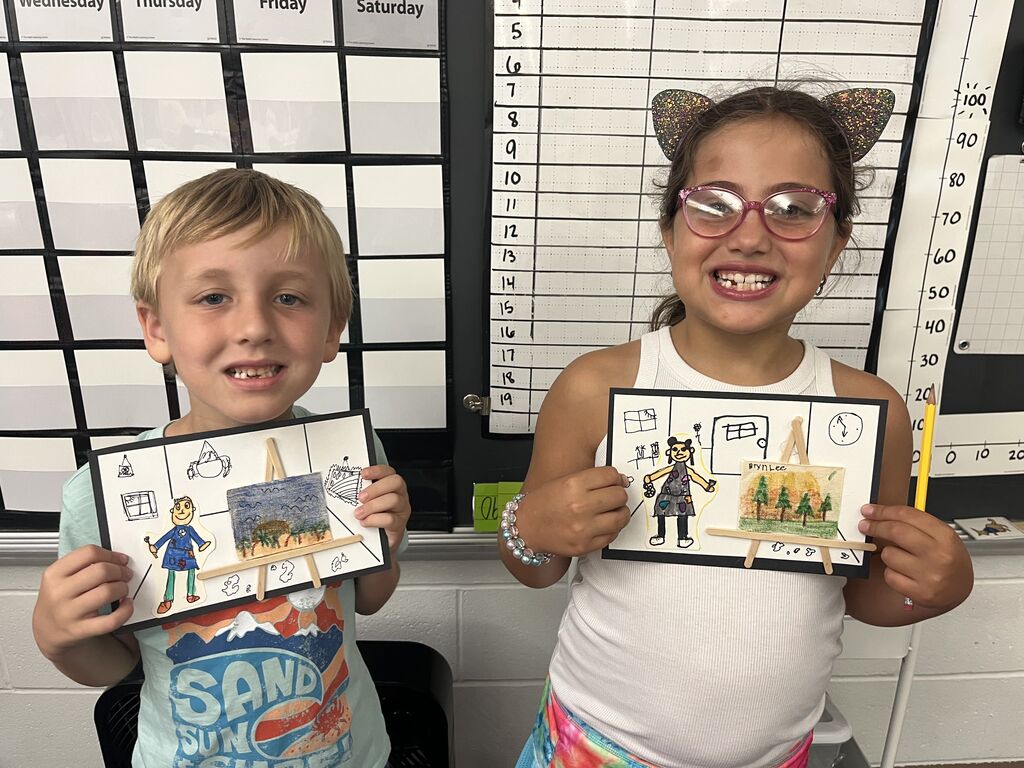 Three Broadway students proudly show off their artwork.  
