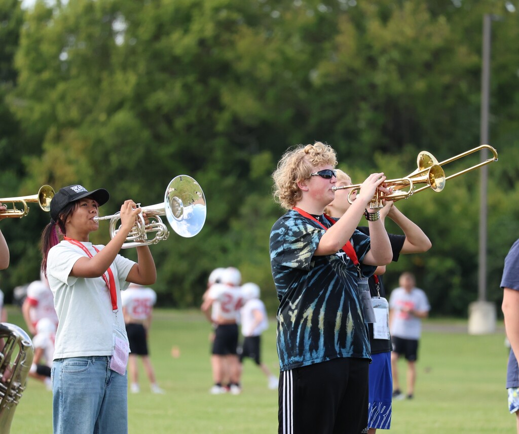THS Marching Band practices after school with their instruments and movements.