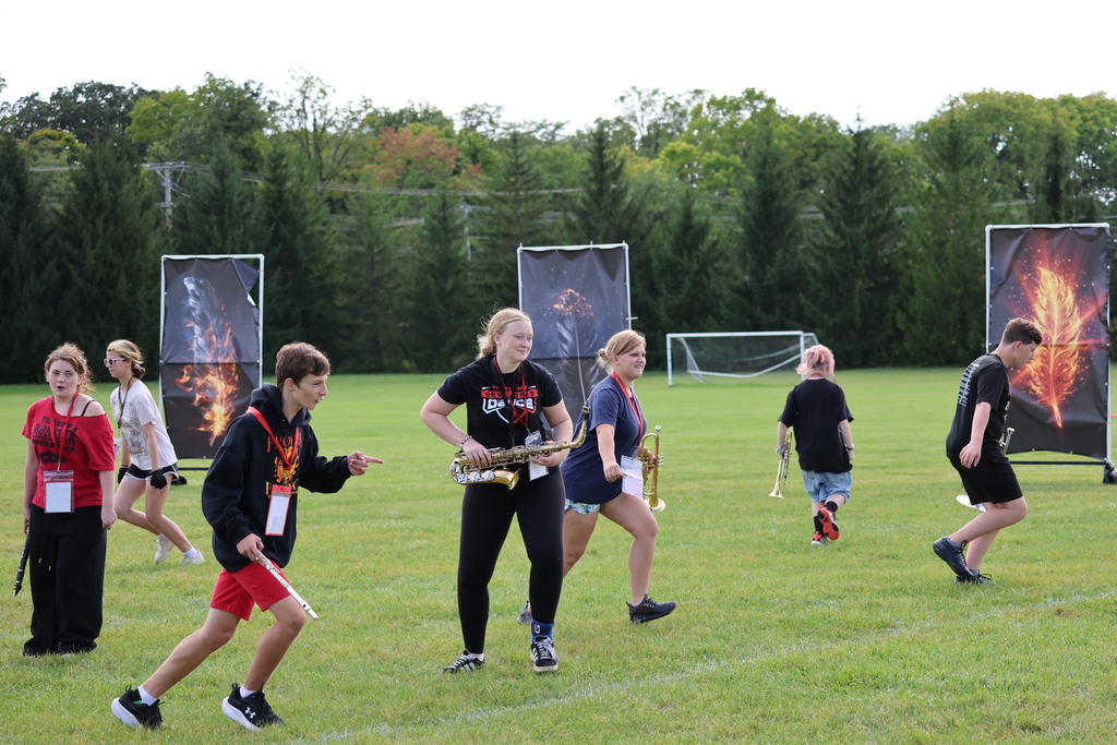THS Marching Band practices after school with their instruments and movements.