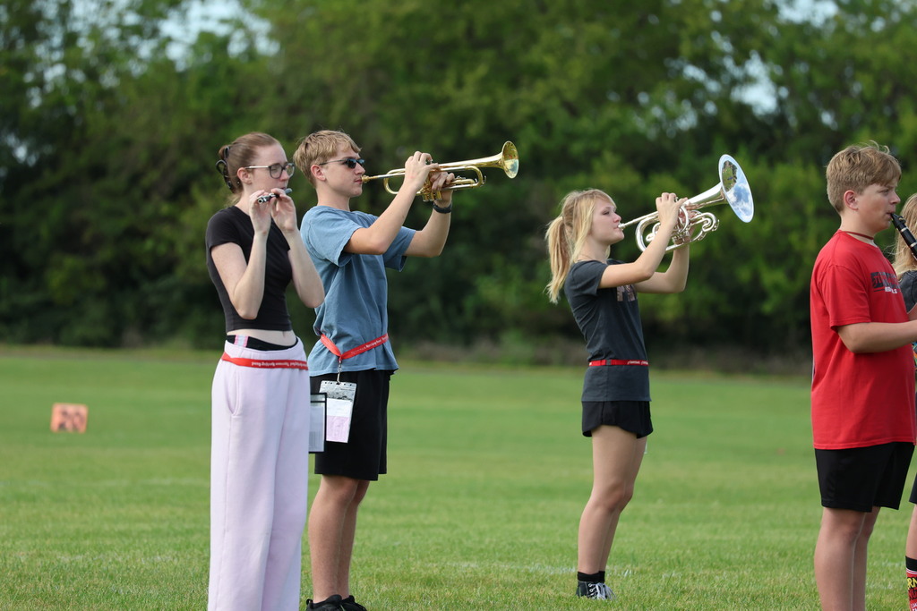 THS Marching Band practices after school with their instruments and movements.