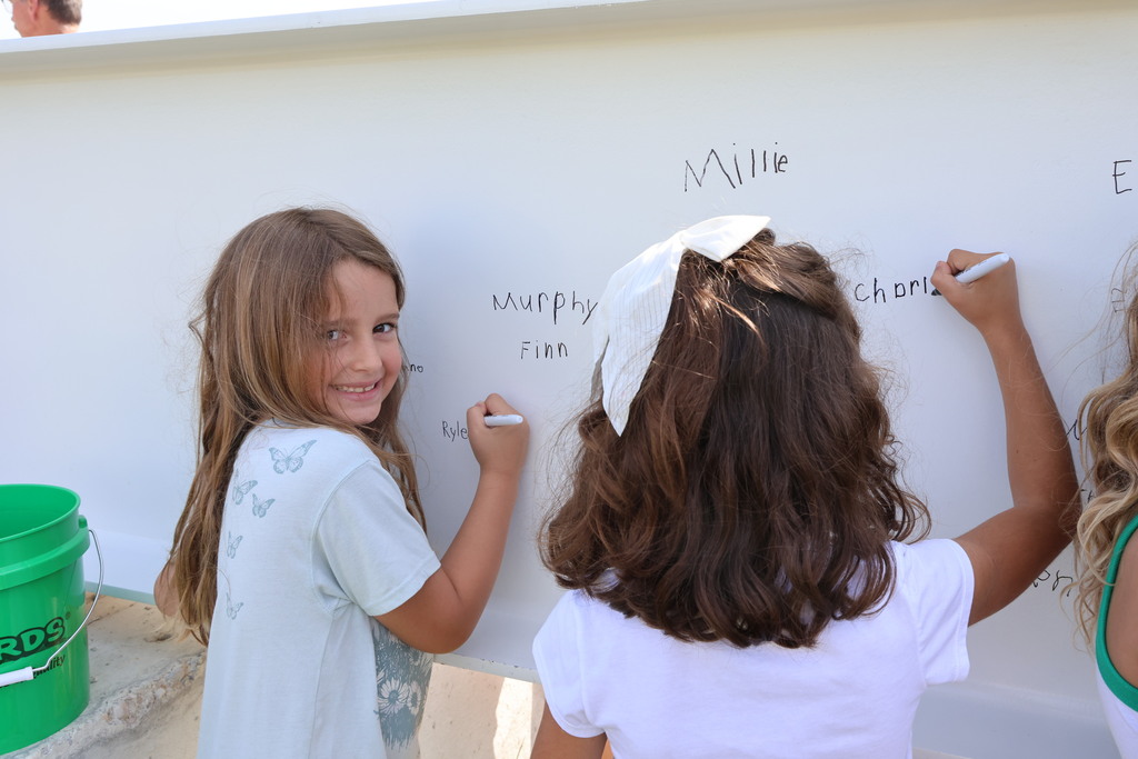 A Broadway Elementary student gets ready to sign the steel beam that will go in the new school.  
