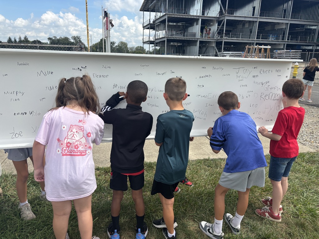 L.T. Ball students sign the steel beam that will go in the new school. 