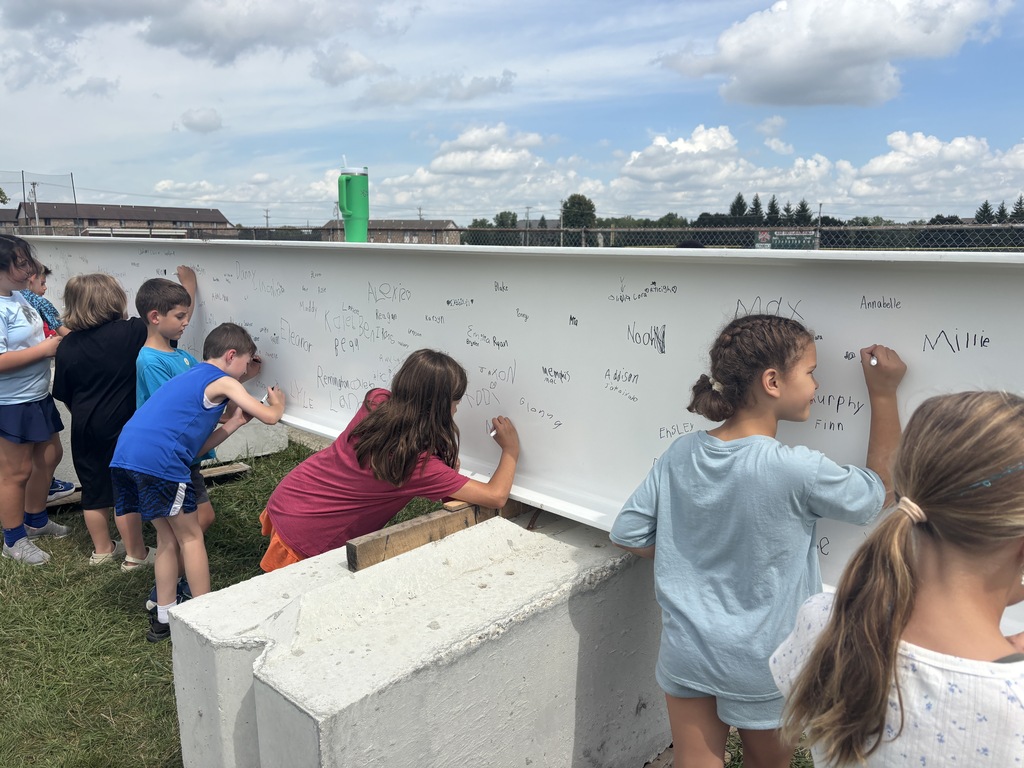 L.T. Ball students sign the steel beam that will go in the new school. 