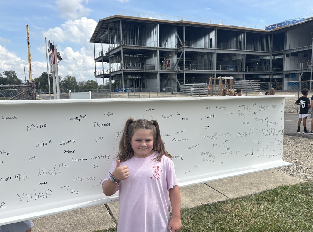 An L.T. Ball student is thumbs up as she gets  ready to sign the beam.