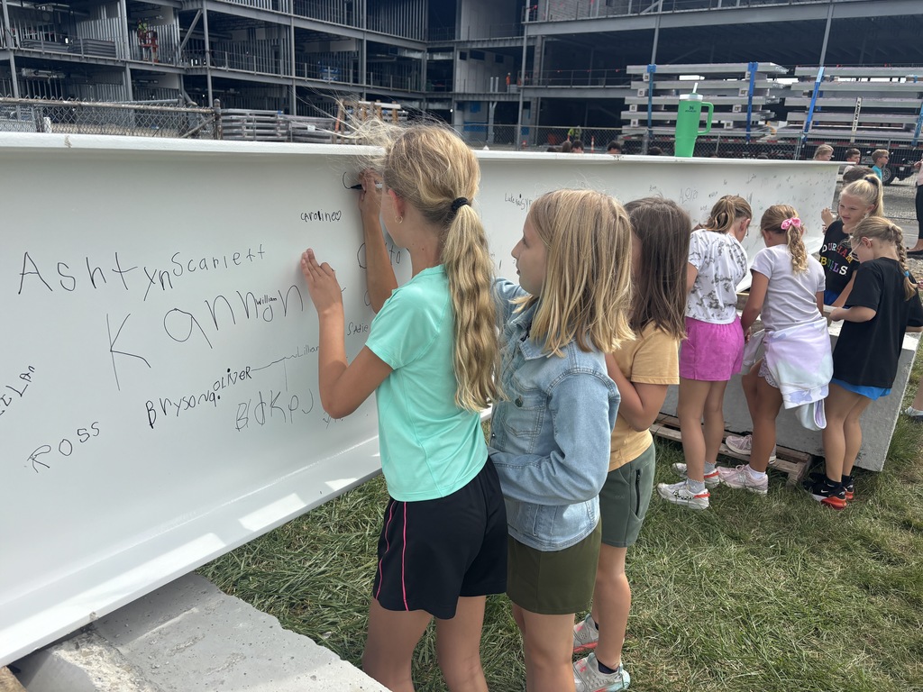 L.T. Ball students sign the steel beam that will go in the new school. 