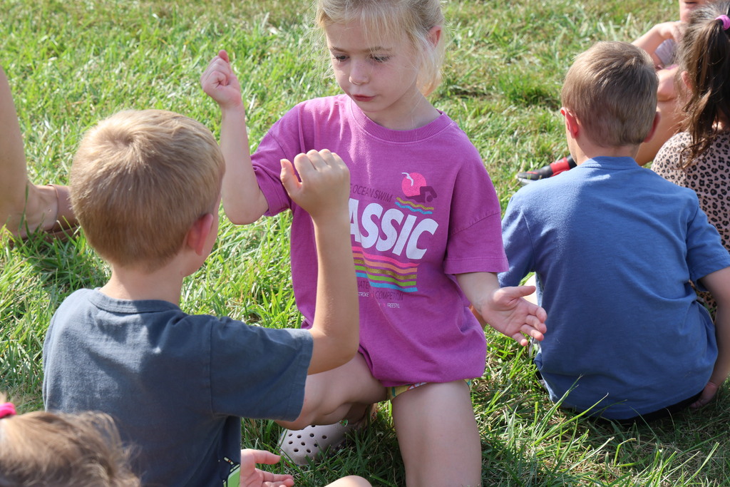 Broadway students keep themselves entertained while waiting for the school bus after signing the beam. 