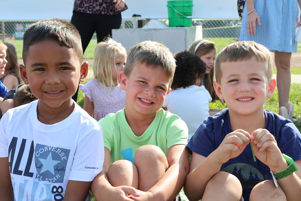 Broadway students pose for the camera while waiting for the school bus after signing the beam. 