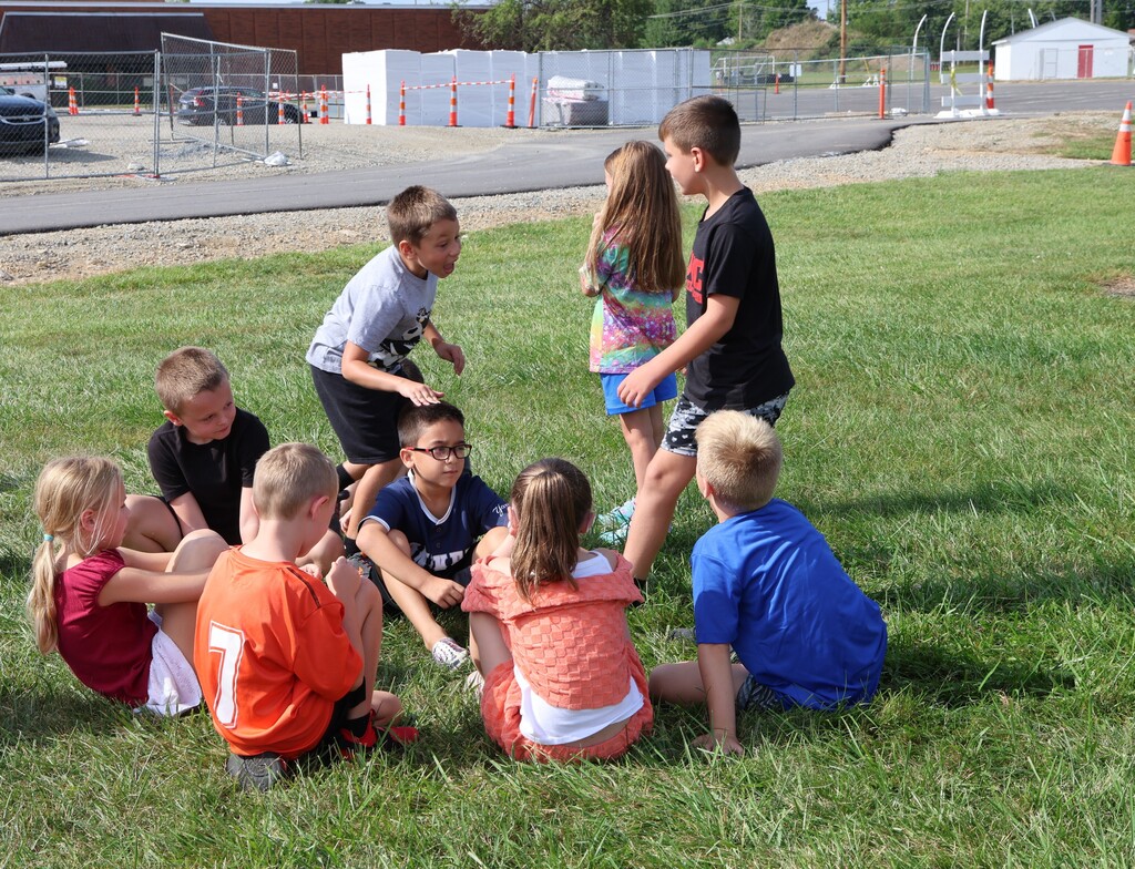 Broadway students keep themselves entertained while waiting for the school bus after signing the beam. 