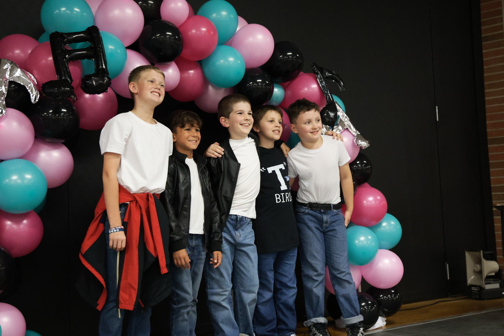 Third graders pose for a picture at the Sock Hop.