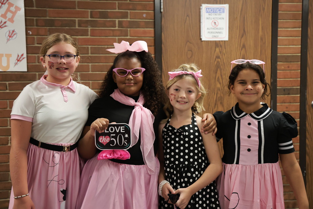 Third graders pose for a picture at the Sock Hop.