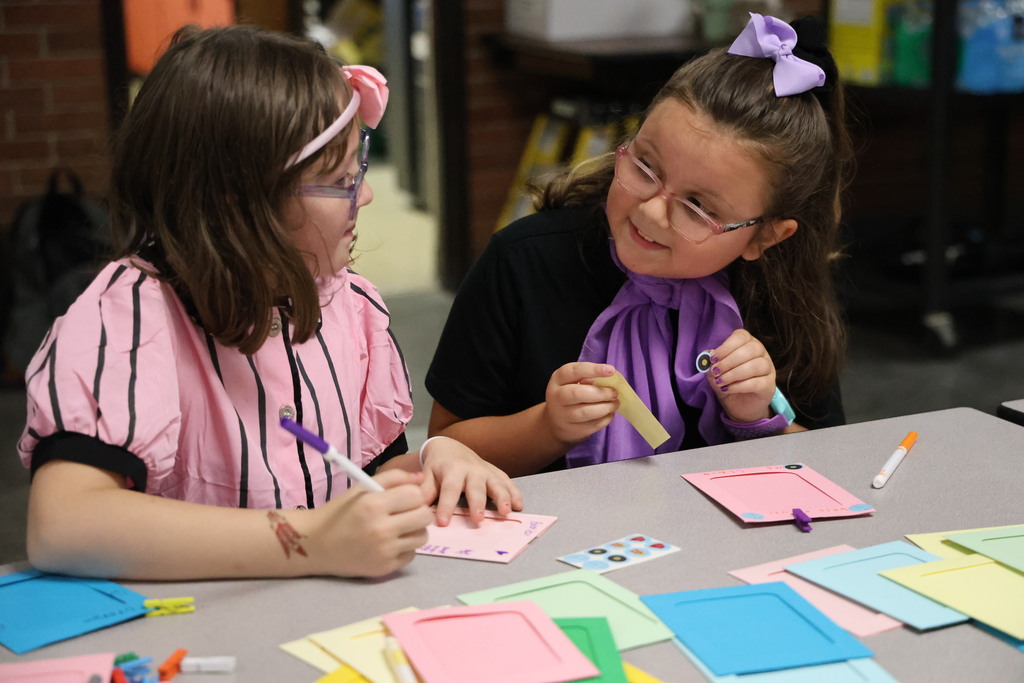 Two girls making photos frames at the sock hop.