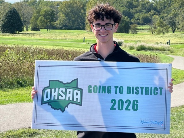 Grant holds his OHSAA sign that says going to district 2026.