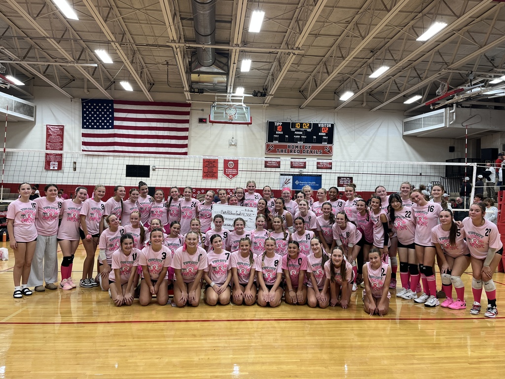 TMS and Troy volleyball teams stand together for a photo after raising thousands of dollars for PRG.