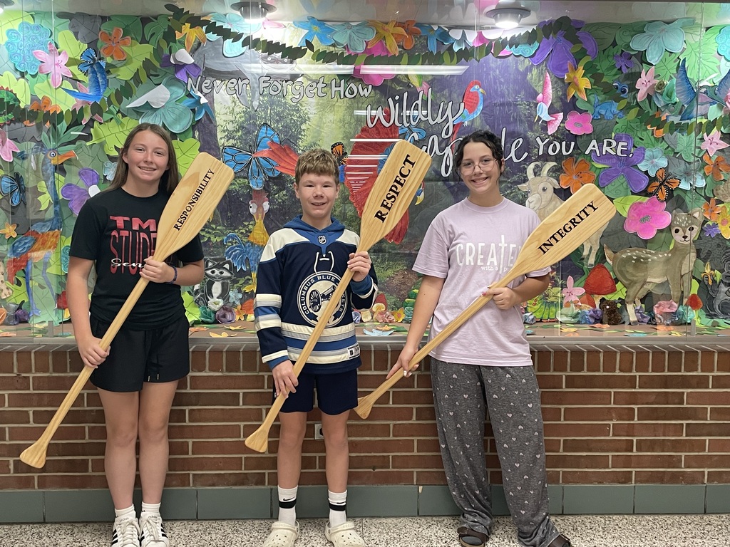 TMS Crew of the Week holding the oars that say responsibility, respect, integrity.