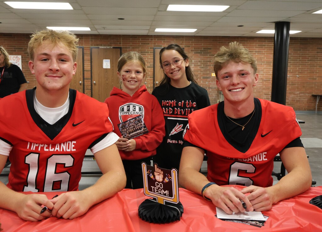 Two THS football players with L.T. Ball fans.
