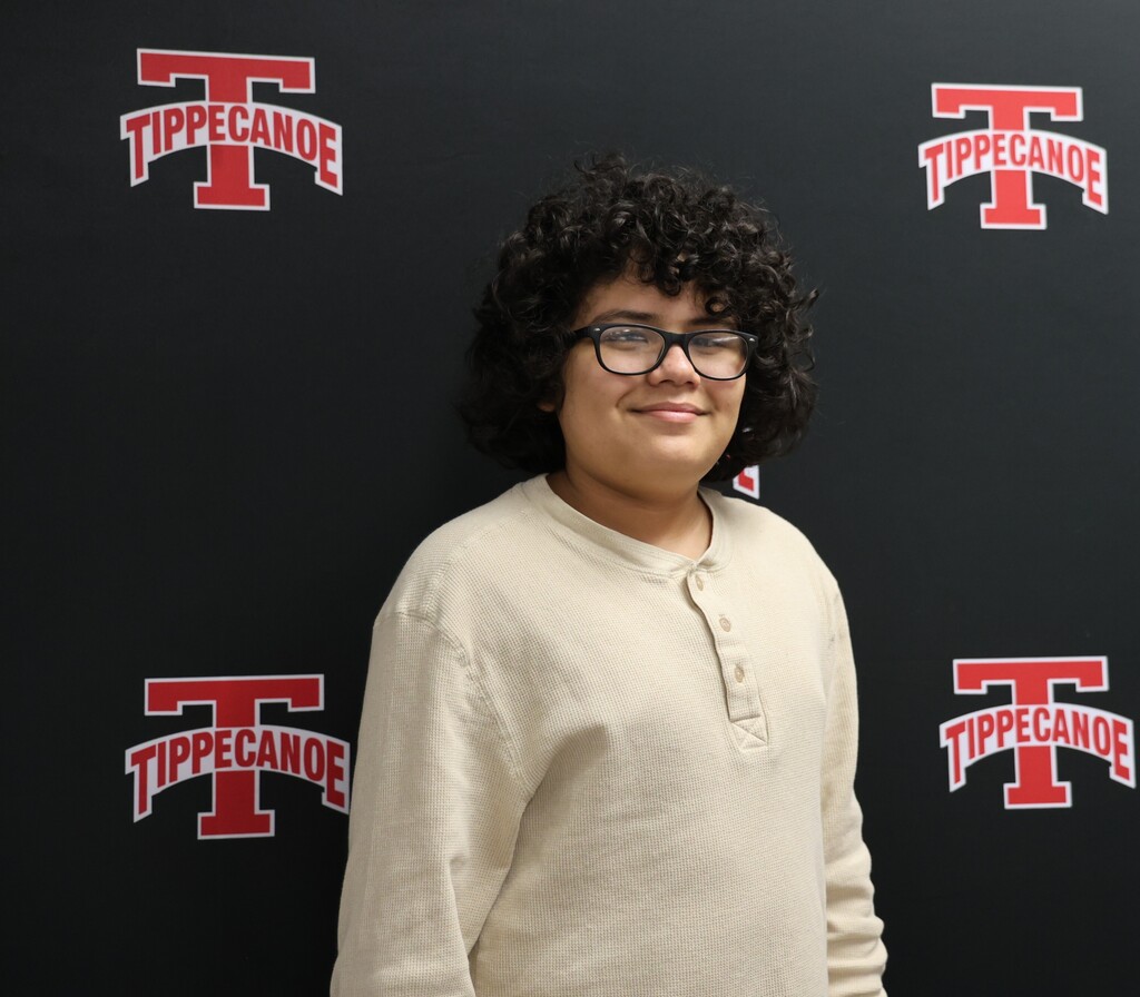 A TMS smiles after being recognized at the Board of Education meeting for his character and school attendance.
