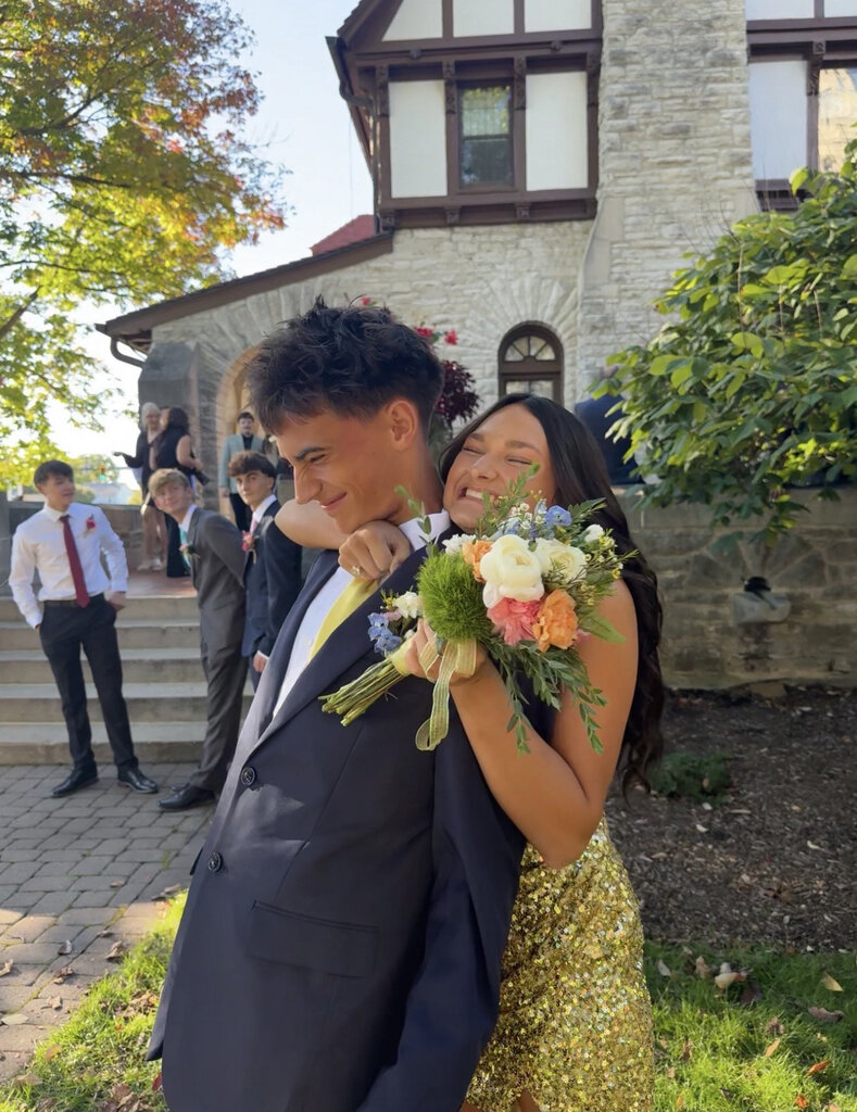 Two students being silly while taking pictures for homecoming.