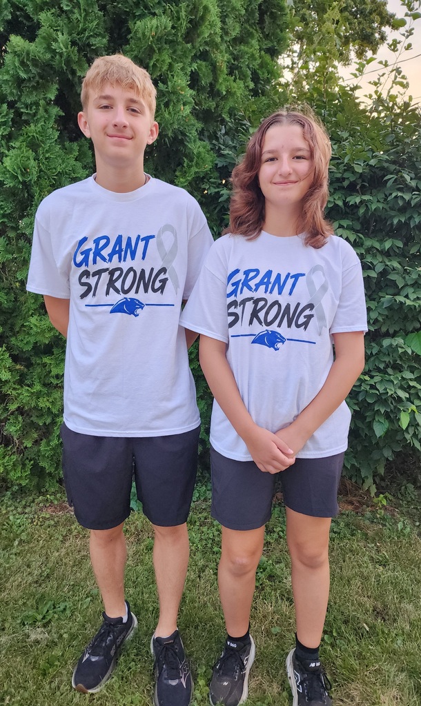 Two students pose with their Grant Strong t-shirts in support of their friend.
