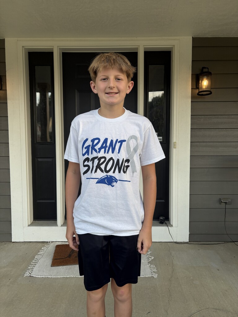 Two students pose with their Grant Strong t-shirts in support of their friend.