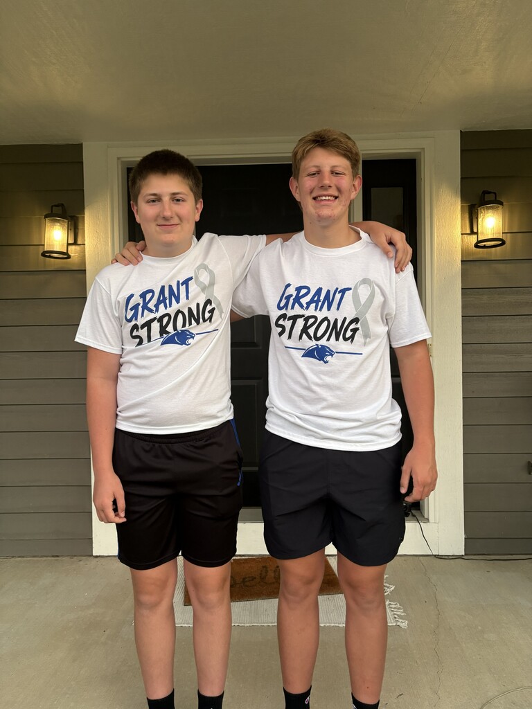 Two students pose with their Grant Strong t-shirts in support of their friend.