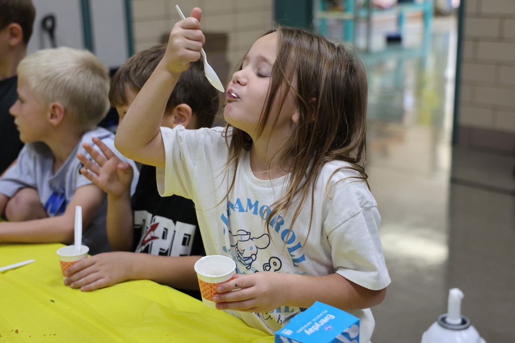 A student is delighted after tasting pumpkin pie with whip cream.