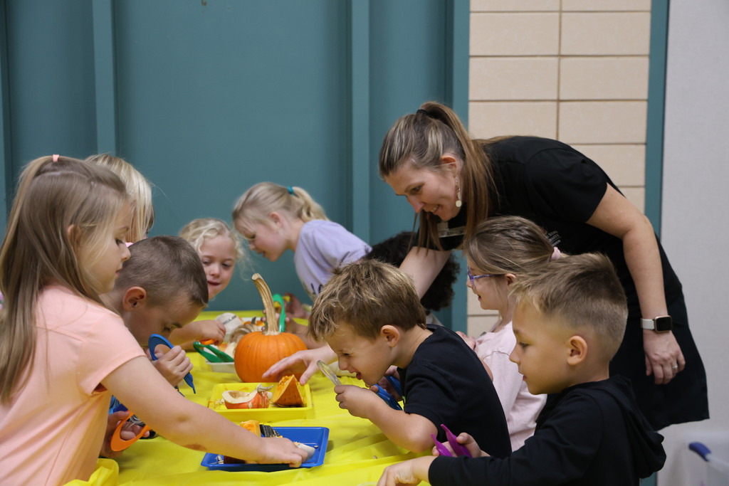A group of students play scientists with tweezer and magnifying glasses.