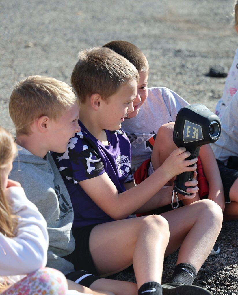 Students look through one of the devices used by firefighters when searching in buildings.