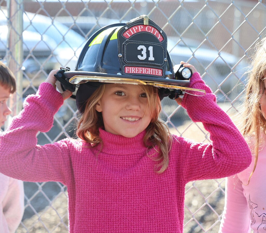 A Broadway student tries on the firefighter helmet.