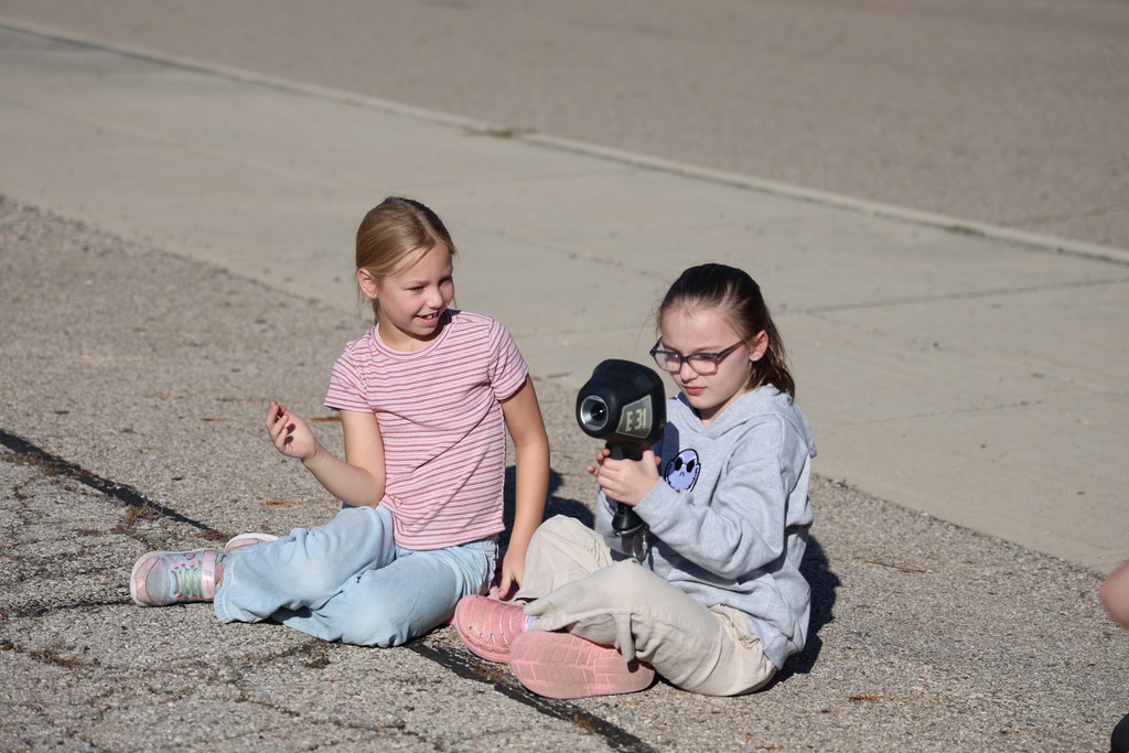 Two students look through a piece of fire fighting equipment.
