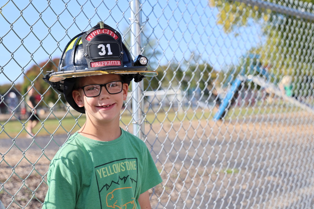 A Broadway student tries on the firefighter helmet.