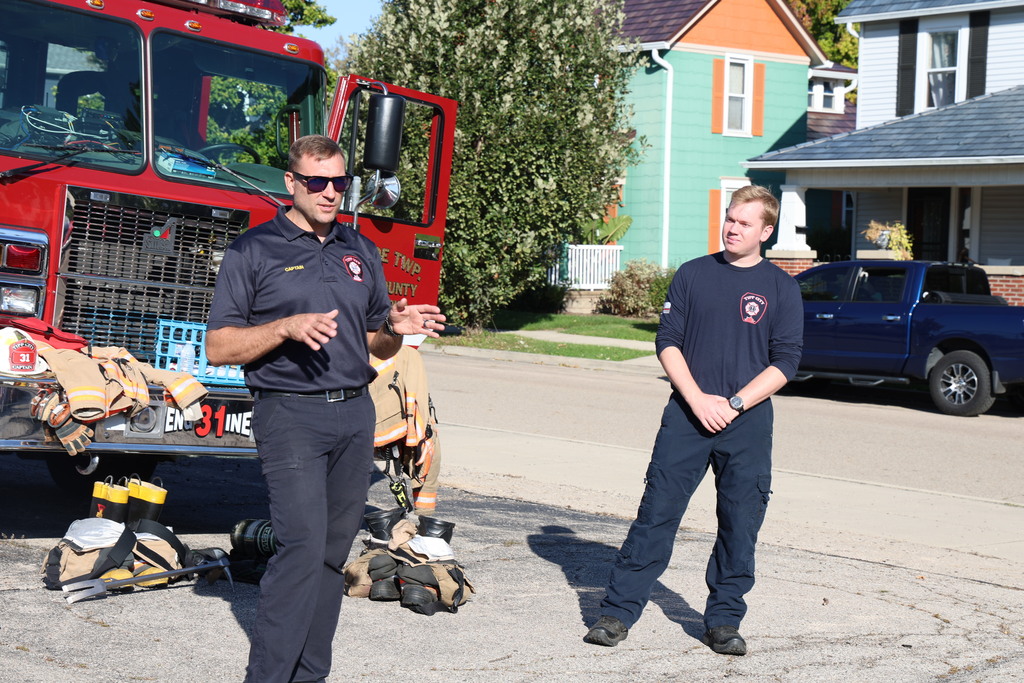 Firefighters talk with students about safety.