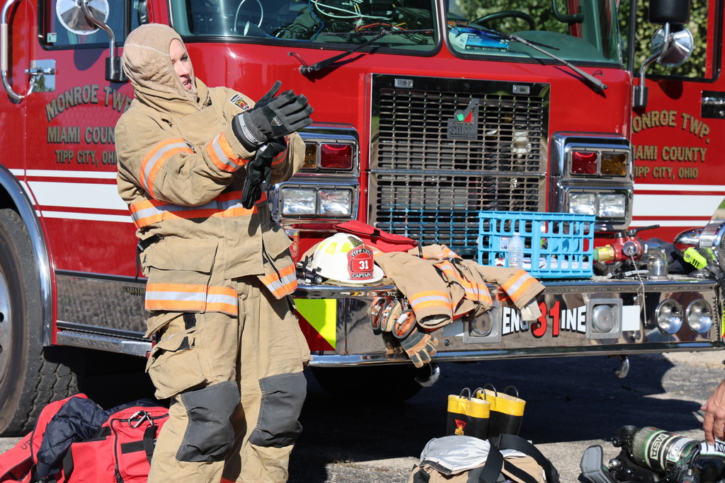 Broadway teacher Mrs. Hamby races to get on the firefighting gear.