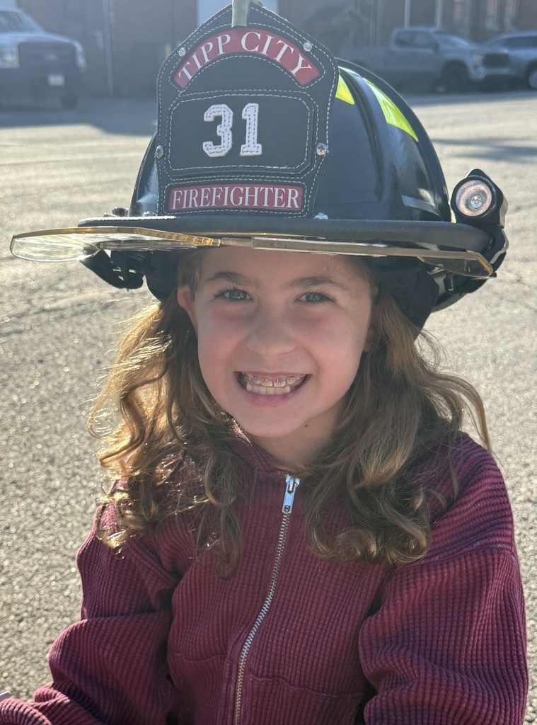 A Broadway student tries on the firefighter helmet.