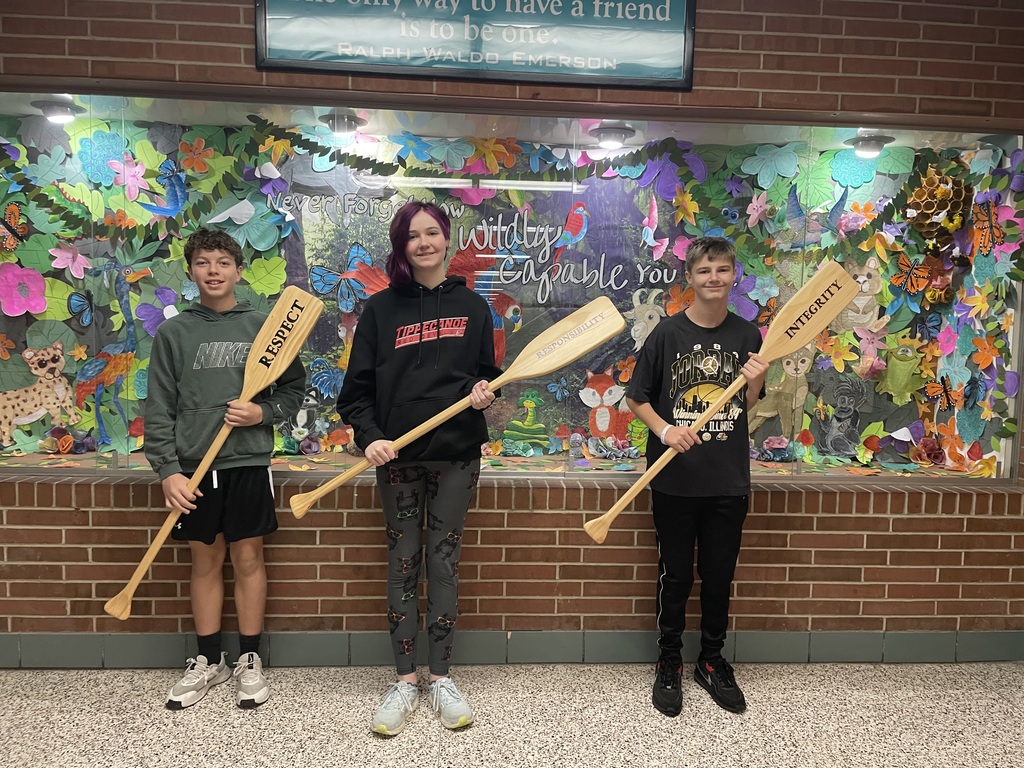 TMS Crew of the Week pose with their oars.