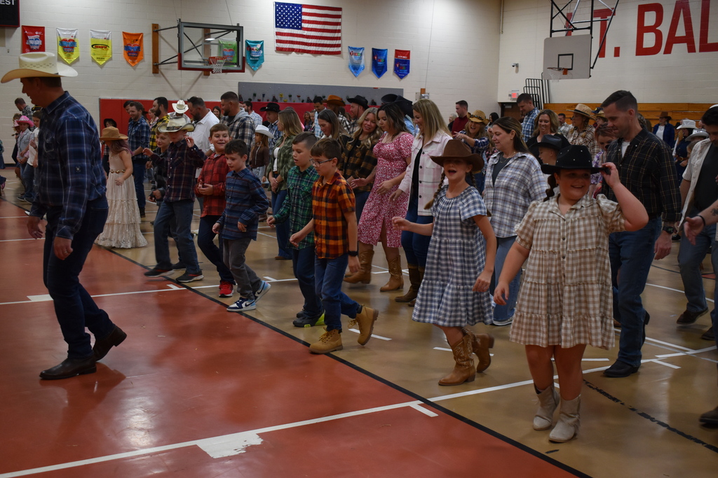 Students and their guests dance at the hoe down.