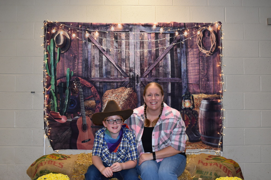 A student and his mom pose for a photo at the hoe down.  