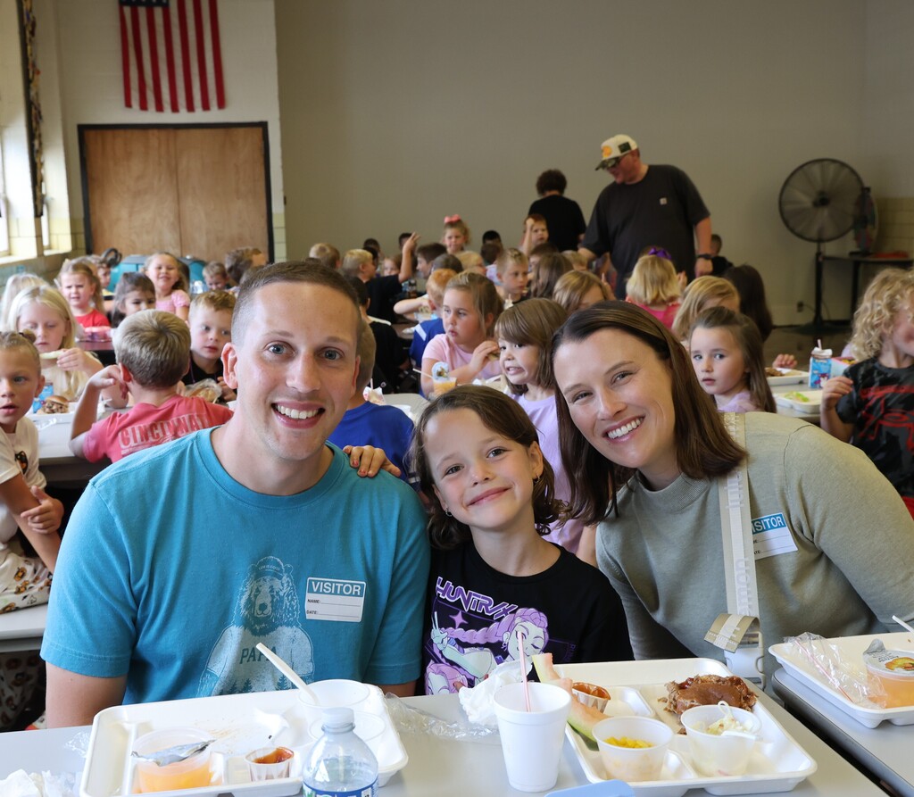 A mom, dad, and their child enjoy lunch at Broadway during National School Lunch Week.