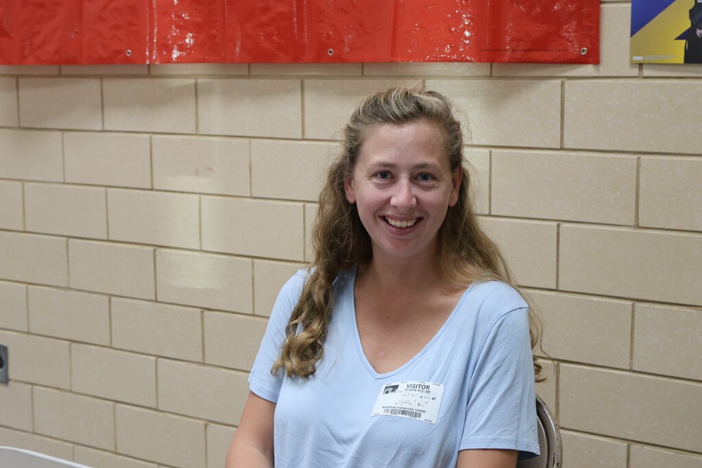 A PIE volunteer is all smiles and ready to check out customers at the book fair.