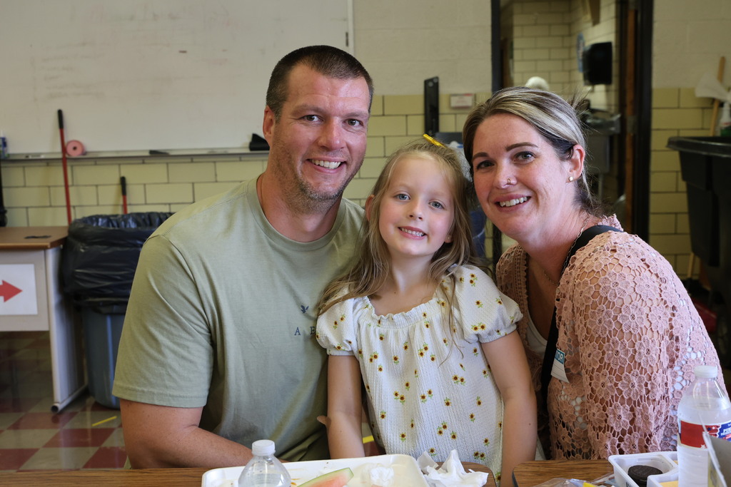 A mom, dad and their daughter enjoy lunch at Broadway during National School Lunch Week.