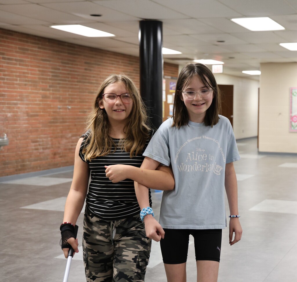 Students practice using a white cane. 