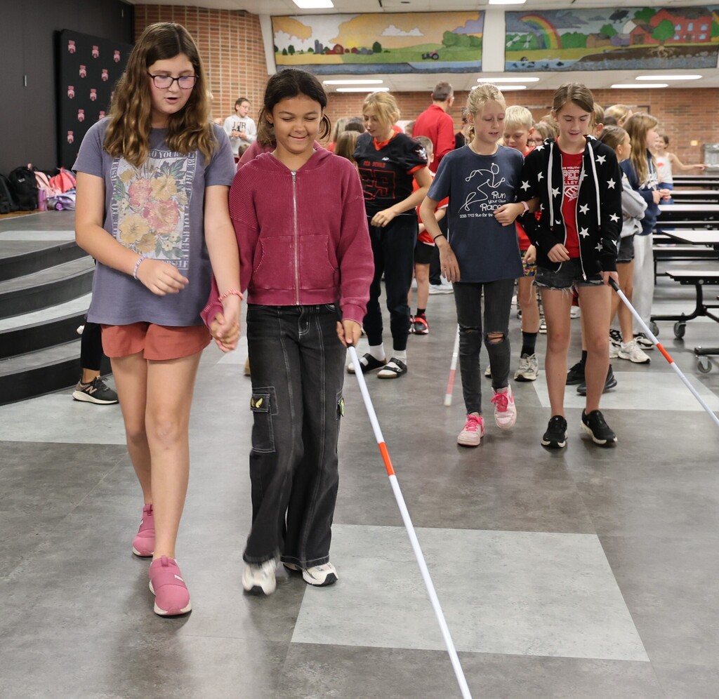 Students at LT Ball practice using a white cane.