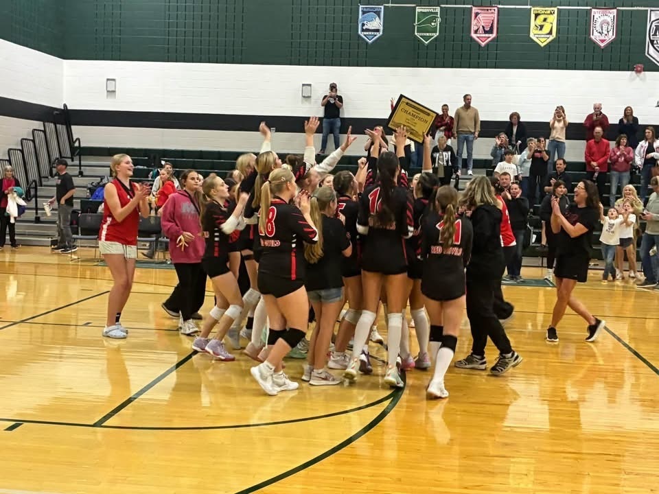 Girls hold up their trophy after winning the MVL championship.