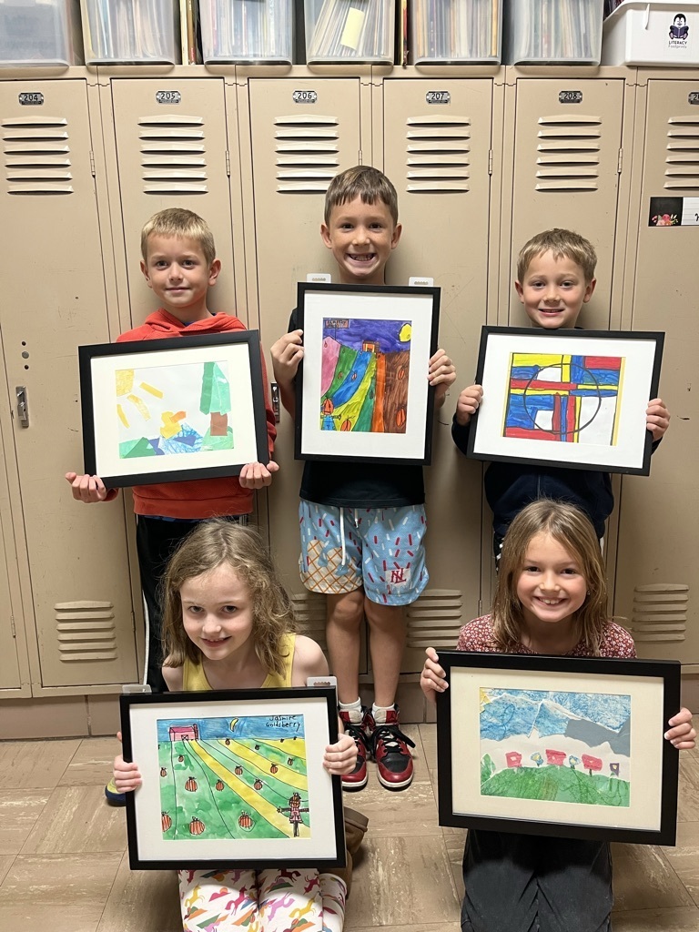 Broadway students pose with their framed artwork. 