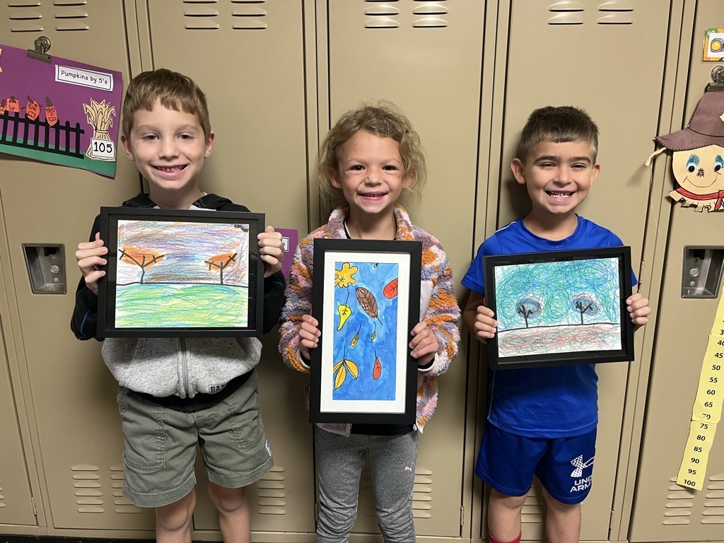 Broadway students pose with their framed artwork. 