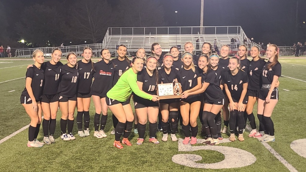 THS girls soccer team holding the MVL Trophy.