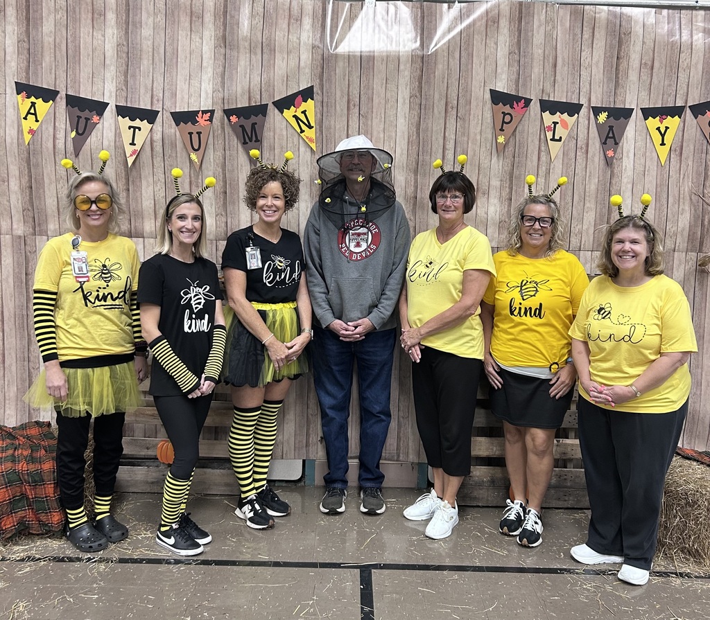 Staff dressed as bees and a beekeeper. Bee Kind.