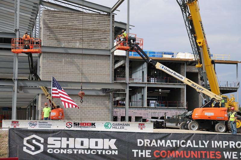The beam sits on the ground before being hoisted.