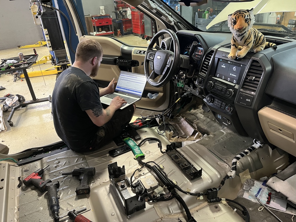 Tank helping diagnose a problem with a car at Ford Dealership