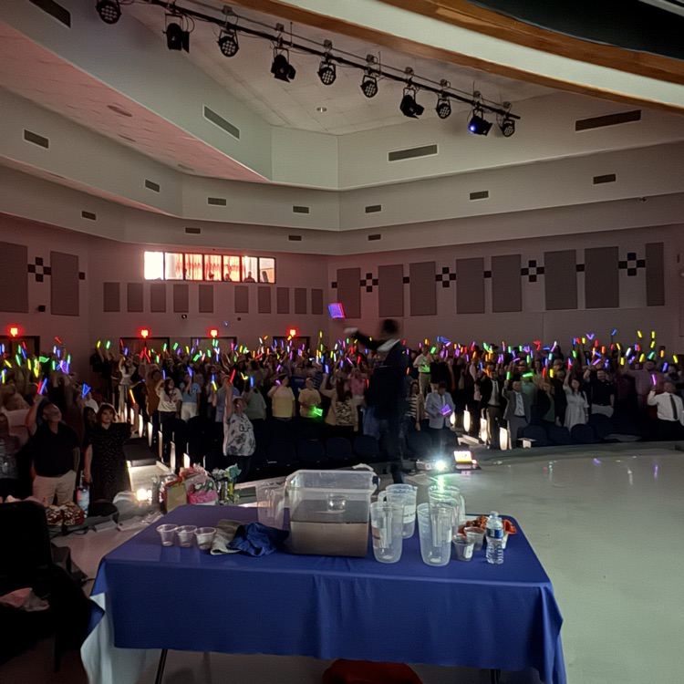 teachers holding glow sticks