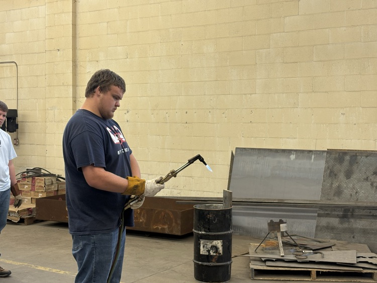 Students practicing lighting a torch in Welding II class